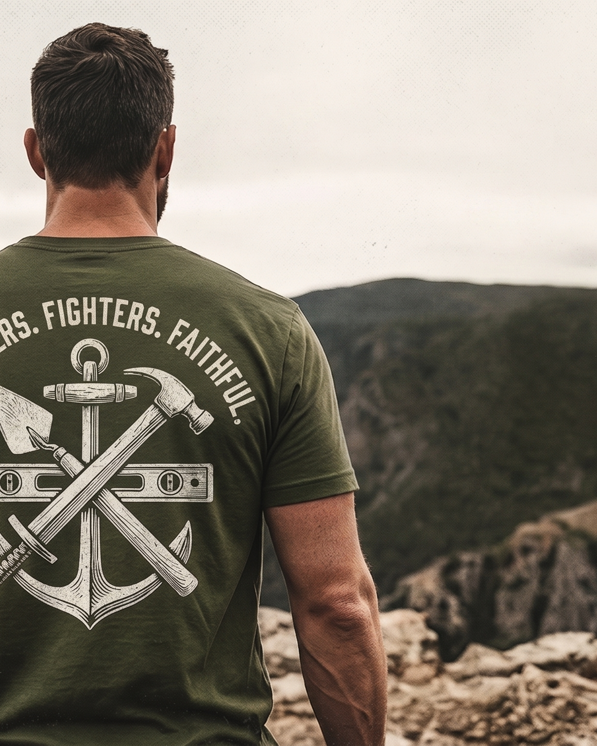 Man wearing a green t-shirt with a design and text, standing on a rocky landscape.